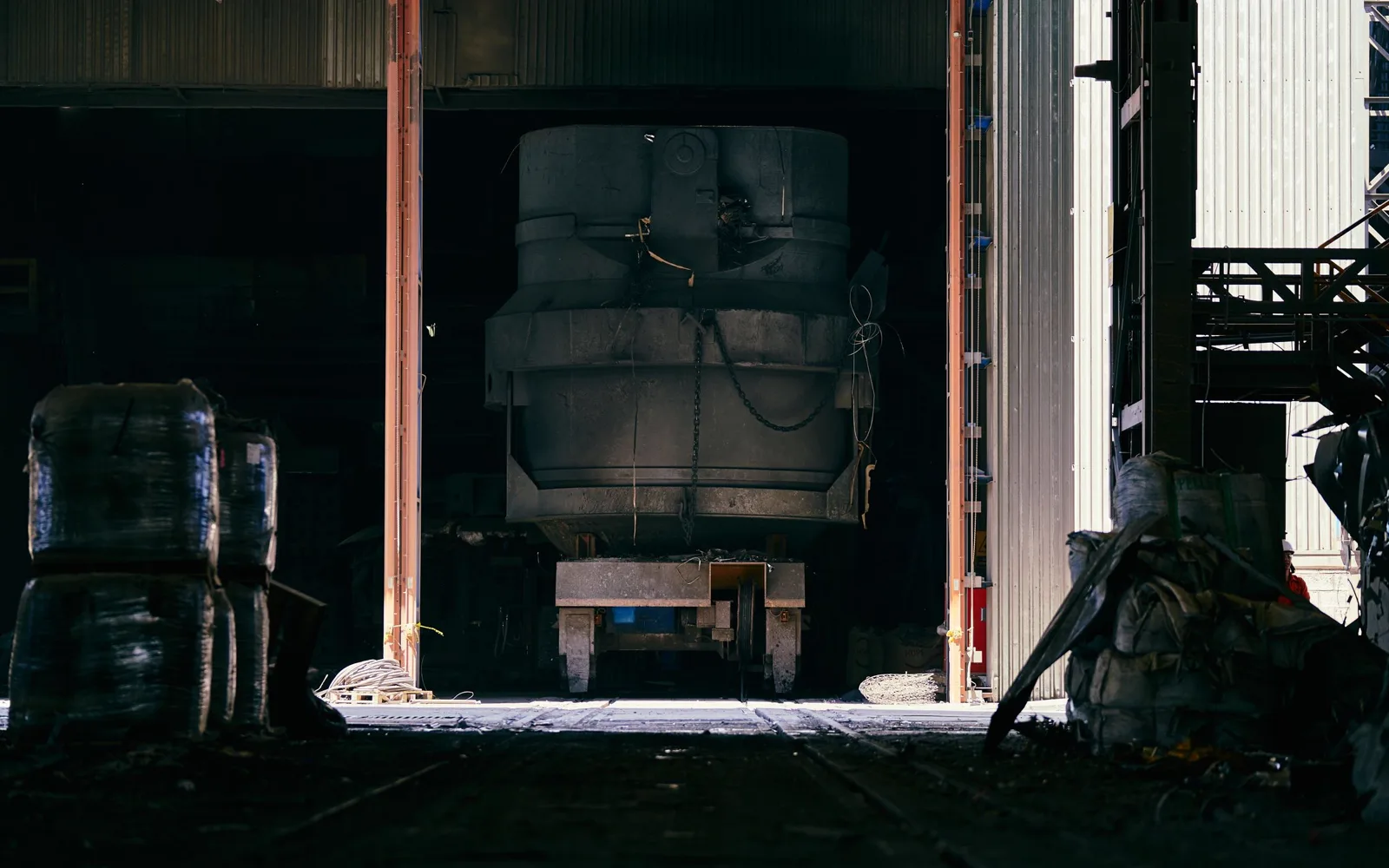 Unbranded industrial machinery in a dim workroom.